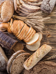 Wall Mural - The bread and a wheat on the wooden desk.