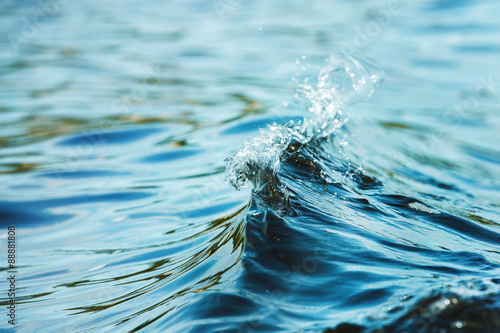 Fotografía Closeup image of water splash outdoors at sea background.