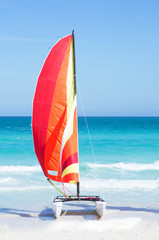 Catamaran with its colorful sails wide open on cayo Santa Maria