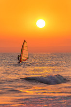 Windsurfer Silhouette At Sea Sunset. Summertime Watersports 