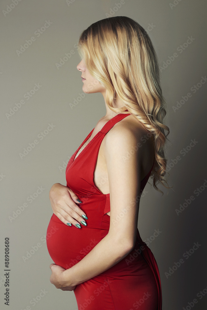 pregnant woman in red dress Happy Young Pregnant Woman in Red Dress Stock Image