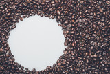 Fototapeta Paryż - Coffee beans texture with a white circle for text