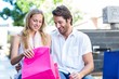 © WavebreakmediaMicro - Smiling couple sitting and looking into shopping bags