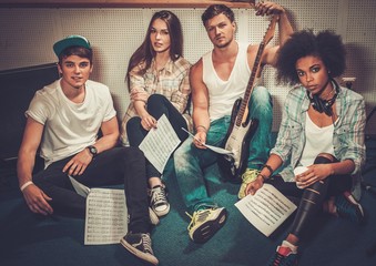 Wall Mural - Multiracial music band performing in a recording studio