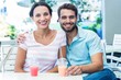 © WavebreakmediaMicro - Happy couple drinking milkshakes together
