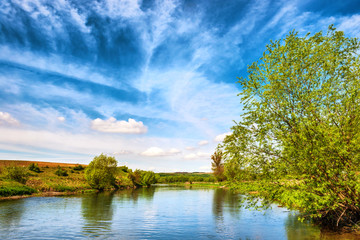 View to river banks with green trees