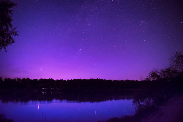 Wall Mural - beautiful night sky with many stars on a lake