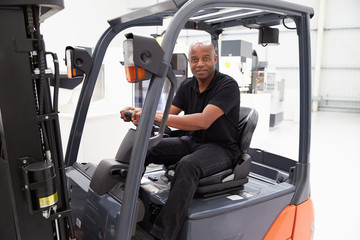 Wall Mural - Portrait Of Male Fork Lift Truck Driver In Factory
