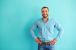 canvas print picture - Happy man in front of turquoise wall