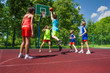 © Sergey Novikov - Team in colorful uniforms playing basketball game