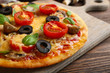 © Africa Studio - Tasty pizza with vegetables and basil on table close up