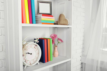 Books and decor on shelves in cupboard