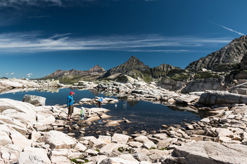 Wall Mural - father with children playing and hiking near glacier lake in austrian alps