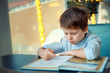 © levranii - Boring and tired little boy reading book