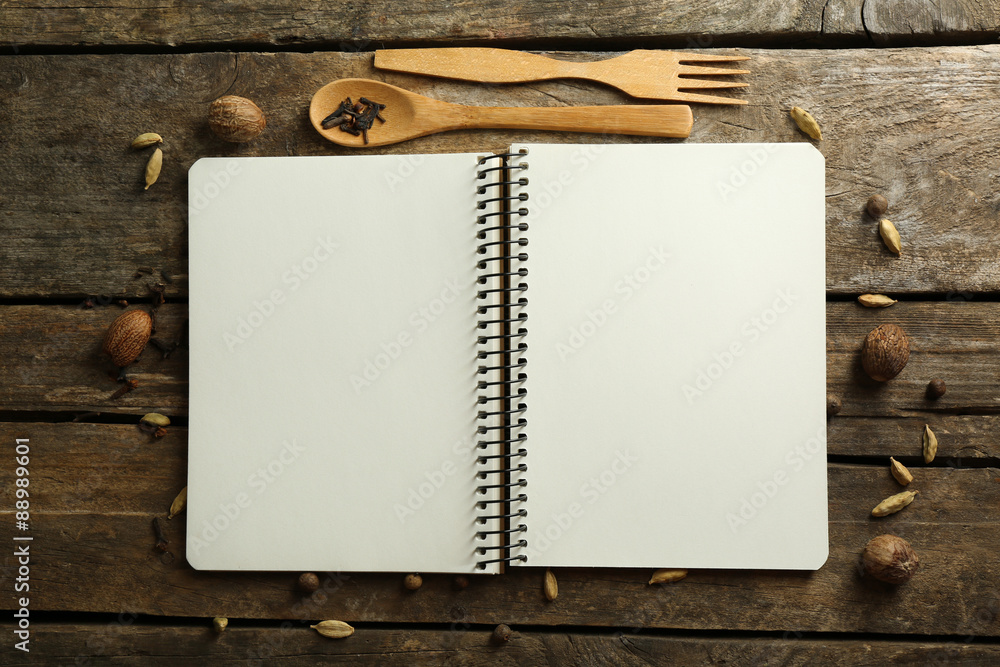 Open recipe book on wooden background