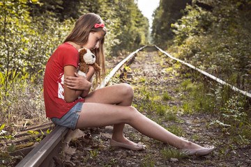 portrait of a sad teenage girl on the railway.