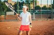 © aboutmomentsimages - young tennis player, sportswoman on clay court with racquet and balls. lifestyle with sport and practice concept