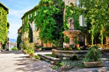 Leafy Town Square With Fountain In A Picturesque Village In Provence, France