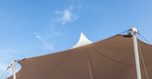 Looking Up At The Top Of White Tent Against Clear Blue Sky Backg