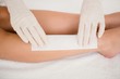 © WavebreakmediaMicro - Therapist waxing womans leg at spa center