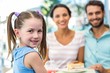 © WavebreakmediaMicro - Portrait of a family eating at the restaurant