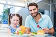 © WavebreakmediaMicro - Daughter and father eating at the restaurant
