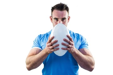 Wall Mural - Rugby player looking at camera with ball