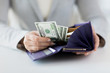 © Syda Productions - close up of woman hands with wallet and money