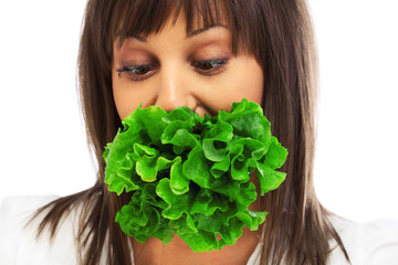 Wall Mural - Young woman eating fresh salad