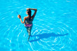 © Drobot Dean - Back view portrait of a woman standing in swim pool