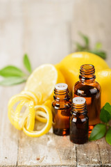 Wall Mural - lemon essential oil and lemon fruit on the wooden board, (taken with tilt shift lens)