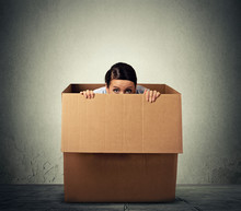 Young Woman Hiding In A Carton Box