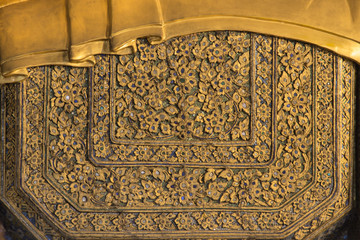 Thai art background on reclining buddha gold statue