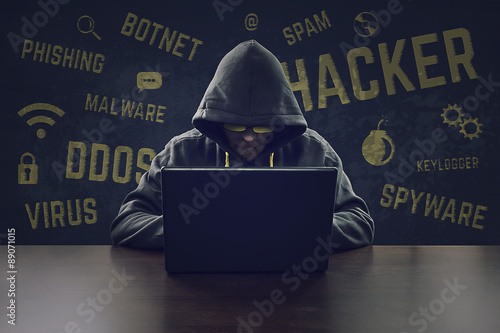 Fotografía Hooded cyber criminal stealing secrets with laptop