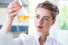 Female Chemist Holding Flask