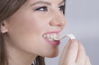 Woman smiling and chewing a gum 