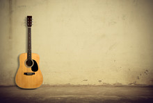 Acoustic Guitar Against Old Wall