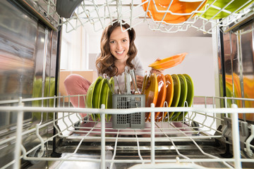 Woman With Plate View From Inside The Dishwasher