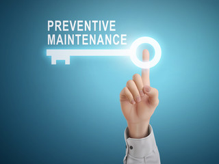 male hand pressing preventive maintenance key button