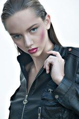 Wall Mural - Fashion girl with pink lips posing in black leather jacket