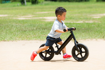 Little boy play with bicycle