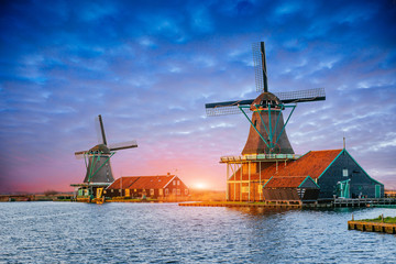 Cumulus clouds on sunset over dutch windmills in Rotterdam. Neth