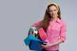 © spaxiax - cheerful woman holding different cleaning stuff