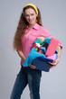 © spaxiax - cheerful woman holding different cleaning stuff