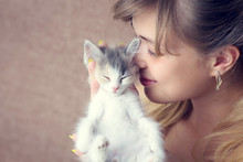 Beautiful Girl Hugging A Small Kitten