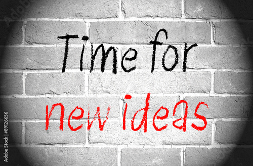 Naklejka na szybę Time for new ideas - text with spotlight on wall