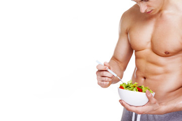 Wall Mural - Strong fitness man holding a bowl of salad, isolated on white ba