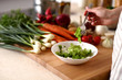 © lenetsnikolai - Cook's hands preparing vegetable salad - closeup shot