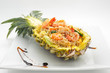 Fried rice with seafood served in a pineapple isolated on white