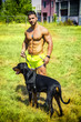 Muscular shirtless man with dobermann dog